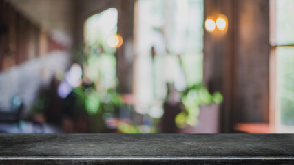 Empty black marble stone table top and blurred coffee shop and restaurant interior background - can used for display or montage your products.