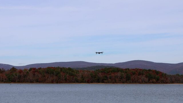 Footage of a drone as it flies up, out and away over Lake Wilhemina, Mena, Arkansas
