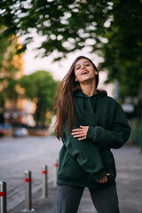 Fototapeta premium Portrait of cute girl with long hair looks at the camera