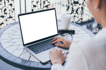 computer mockup image blank screen.hand woman work using laptop with white background for advertising,contact business search information on desk at coffee shop.marketing and creative design