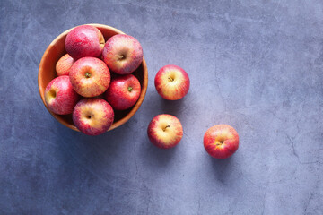 Close up of fresh apple in a bowl on wooden table 