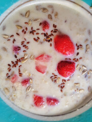 milk soup with strawberries, seeds and grains.