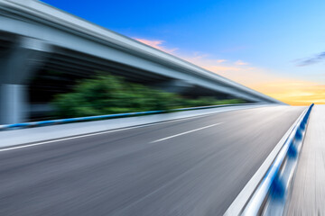 Fototapeta na wymiar Fast moving asphalt road and bridge background.