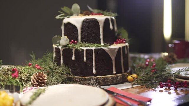 Defocused shot of delicious Christmas dinner table gingerbread cake in New Year eve cozy decoration festive atmosphere