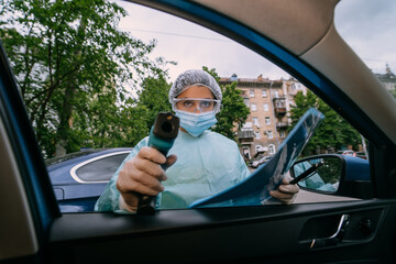 Doctor woman use infrared thermometer gun to check body temperature