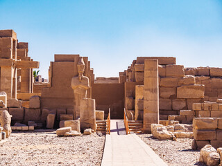Ancient ruins in Karnak temple, long view. Sculpture and ruind brickwall in Luxor. Photographed in...