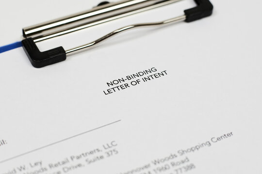 An unrecognizable person filling non-binding letter of intent. Close-up view