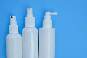 .Cosmetic bottles Mockup. White plastic bottles on a  blue background. Beauty and health concept.Hand disinfector Bottle Set