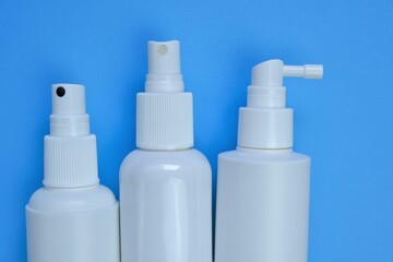 .Cosmetic bottles Mockup. White plastic bottles on a light blue background. Beauty and health concept.Hand disinfector Bottle Set