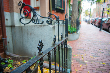 Fototapeta na wymiar Selective focus on foreground in street scene in plush residential suburb in Boston New England.