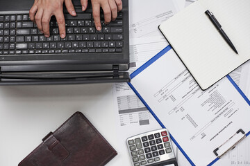 Calculating export import cost. Stack of statistic data, calculator and notepad. Detailed reviewing...