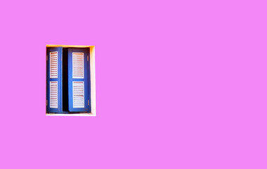Blue wooden windows on the pink walls