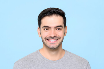 Friendly handsome smiling Caucasian man isolated light blue background