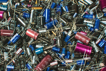 Close up of Electrolytic capacitor heap with various sizes background
