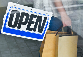 Reopening for business after lockdown quarantine. Women holding shopping bags adapt to new normal...