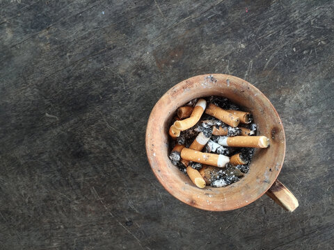 Cigarette filter In a wooden cup, relaxation concept