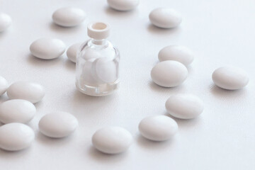 plastic bottle and pills on white background