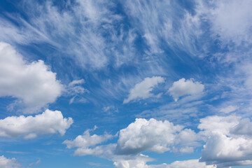 Blue sky background with white clouds.