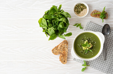 cream soup with spinach, cabbage and sesame seeds, top view