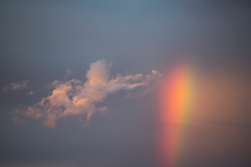 Dramatic sunset sky with rainbow.