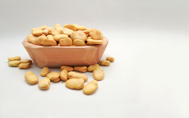 Broad Beans, Also called Fava or Windsor Bean in wooden bowl on white background. copy space