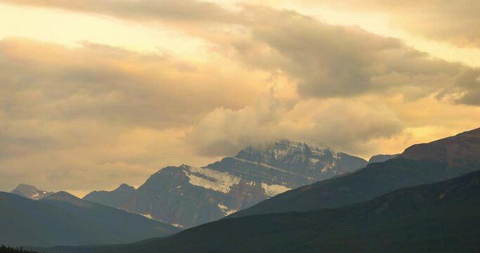 Lockdown time lapse shot of clouds covered Mount Edith Cavell against sky at national park during sunset - Jasper National Park, Canada
