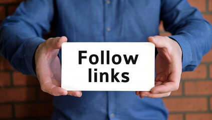 Follow links - seo concept in the hands of a young man in a blue shirt