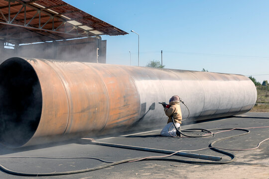 View of sandblasting before coating. Abrasive blasting, more commonly known as sandblasting, is the operation of forcibly propelling a stream of abrasive material against a surface.