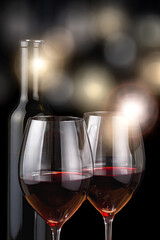two glasses and bottle with red wine and bright background