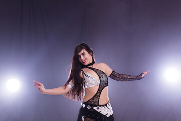 Young woman dancing in Tribal Fusion style. Belly dance on the stage.