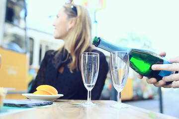 glasses of toast chin chin, hands with glasses of white wine in a street cafe