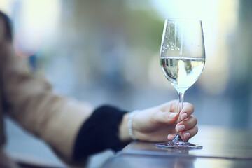 white wine glass in an outdoor cafe, spring view in a restaurant