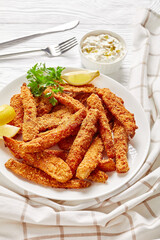 breaded fish sticks on a white plate