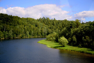 Fototapeta na wymiar Beautiful Norway forest landscape with green mountain and blue lake in a summer sunny day
