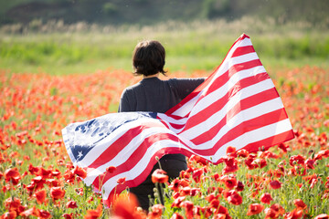 Patriot woman holding the american flag on the 4th of July