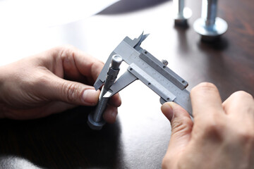 Inspector is measuring diameter of the bolts with a manual verniel caliper micrometer gauge. The...