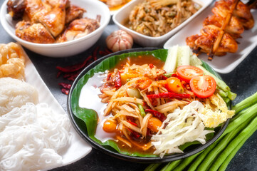 Green papaya salad with grilled chicken, slide grilled pork salad and spicy shredded bamboo shot salad. Thai northeast food.