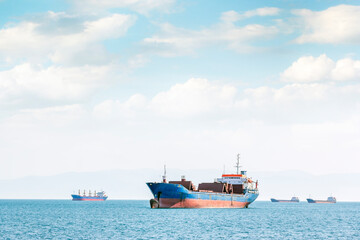 View of the cargo ships or bulk carrier and cloudy sky in Gulf of Izmit, Kartal, Istanbul, Turkey.