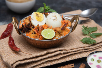 Egg Biryani or Indian anda rice - Basmati rice cooked with masala roasted eggs and spices and served with yogurt popular rice food in India