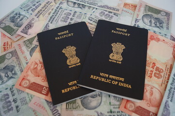 Indian passport with currency as background