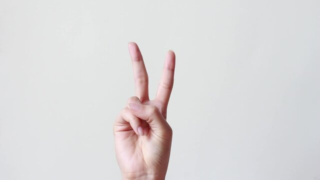 Female one hand holding two fingers up in sign language.two fingers up and showing peace or victory symbol or letter V.