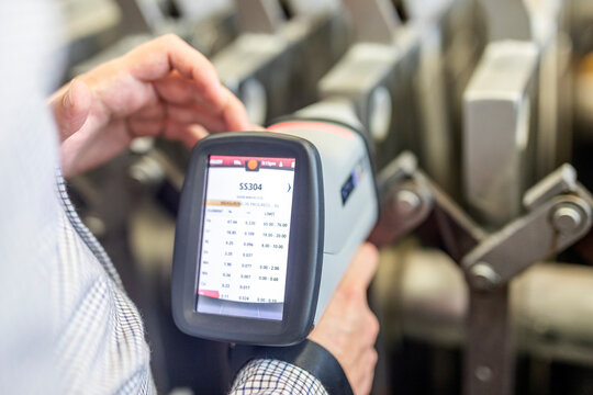 The inspector is material analysis (pmi and xrf) is measuring in stainless steel (ASTM A 304-SS304 material) with digital portable material analyzer.