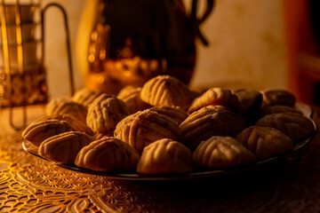 Eid sweets served with head scarf as background