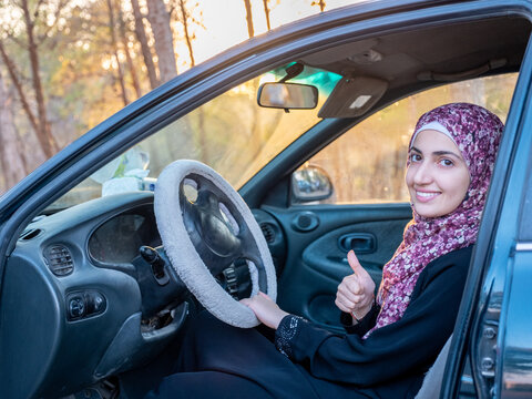 Professional muslim woman driving her car