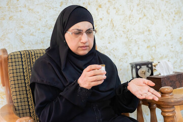 Muslim woman drinking arabic coffee