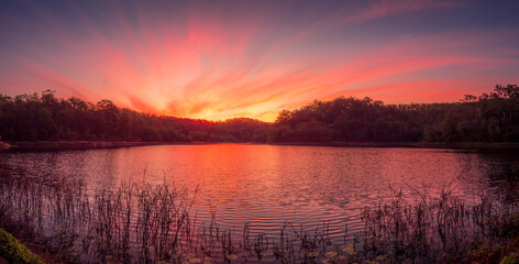Fototapeta na wymiar Beautiful Panoramic Lakeside Sunset with Reflections