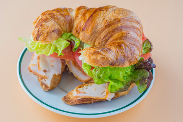Sandwich of croissant of lettuce, tomato and smoked turkey