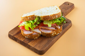 Sandwich of tomato, lettuce and smoked turkey