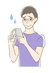 スマホを操作して不安な男性