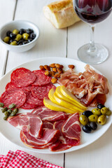 Wine snack. Prosciutto, Parma ham, salami, almonds, olives, baguette, blue cheese, parmesan. Antipasti.